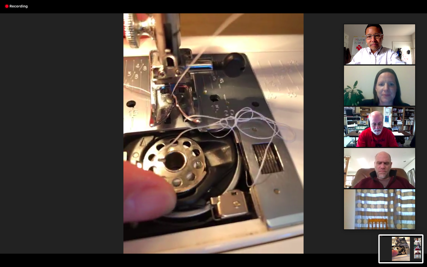 Screenshot of Zoom call with participants looking at a sewing machine bobbin